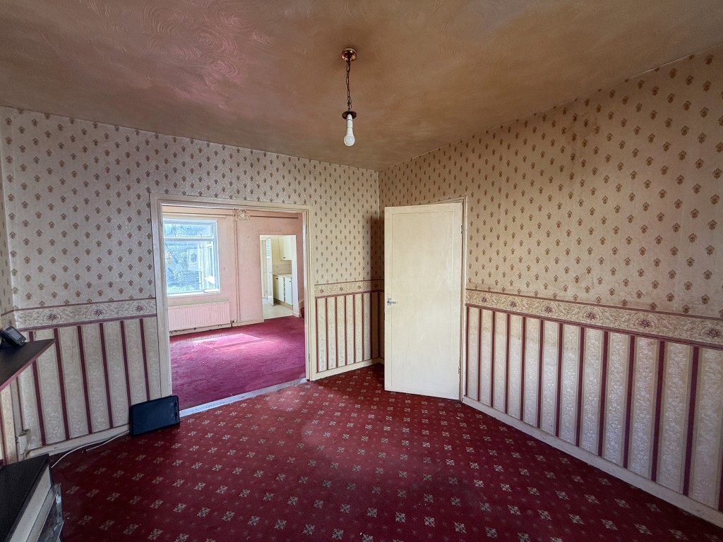 Lot: 109 - TWO-BEDROOM HOUSE IN NEED OF IMPROVEMENT - Living room with view towards dining room